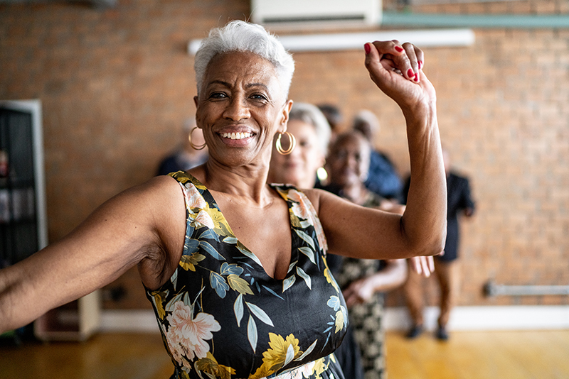 Portrait of a senior woman dancing with her friends on a dance hall